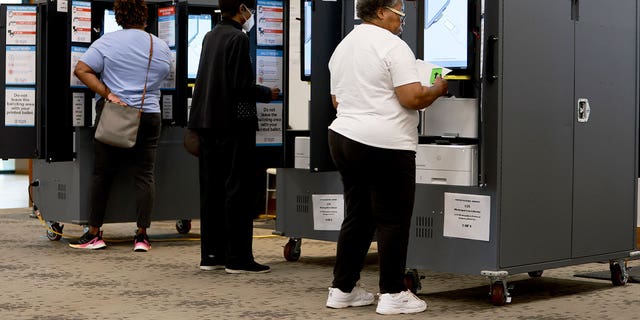 People use voting machines to fill out their ballots as they vote in the Georgia primary at the Metropolitan Library on May 24, 2022, in Atlanta.